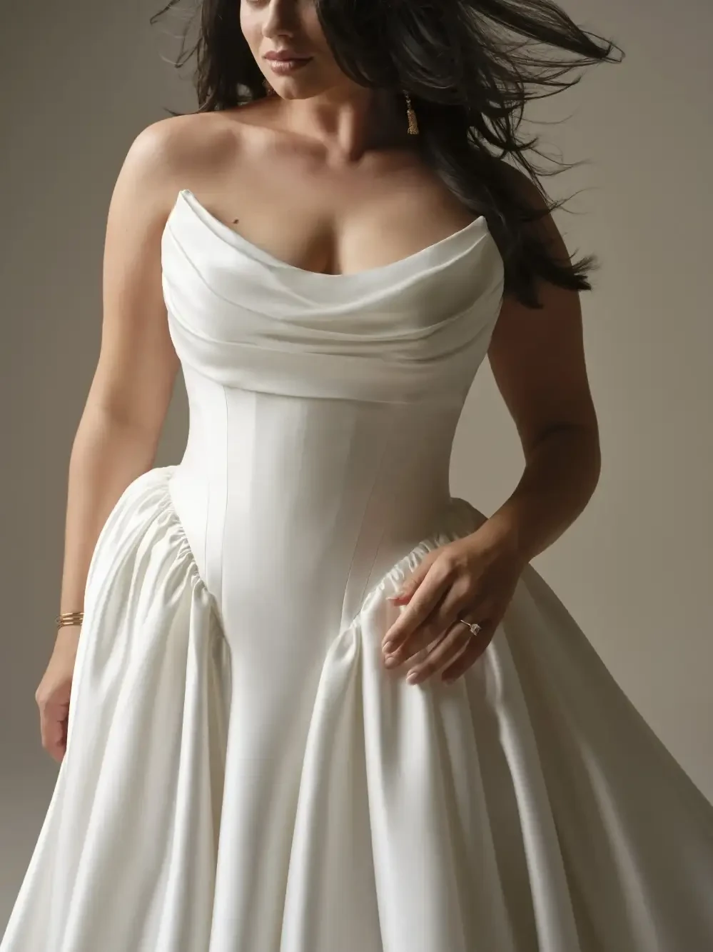 model is wearing a strapless basque waist ball gown