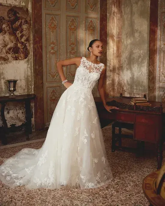model is wearing a high neckline sleeveless a-line wedding dress
