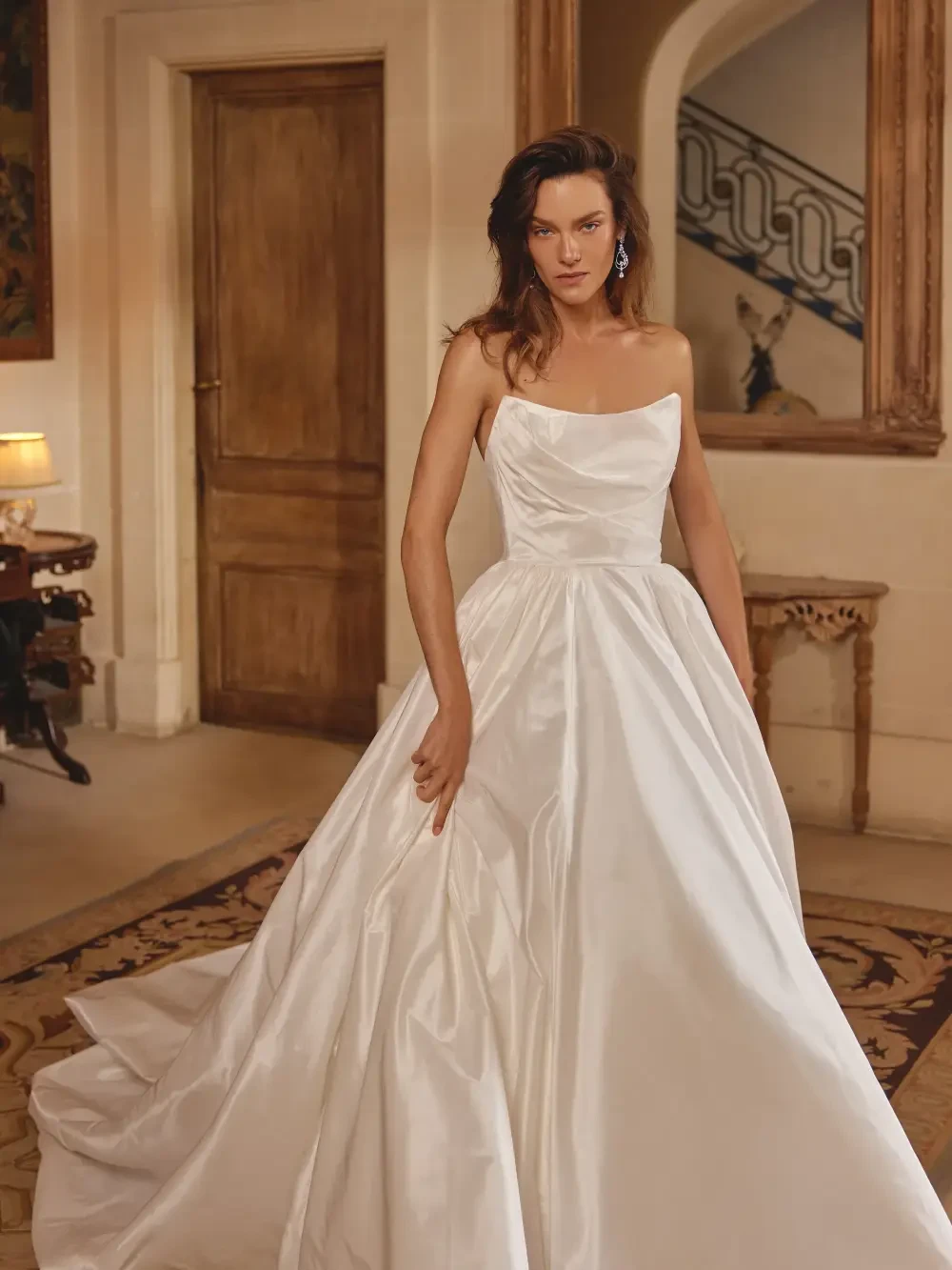 model is wearing a strapless ball gown
