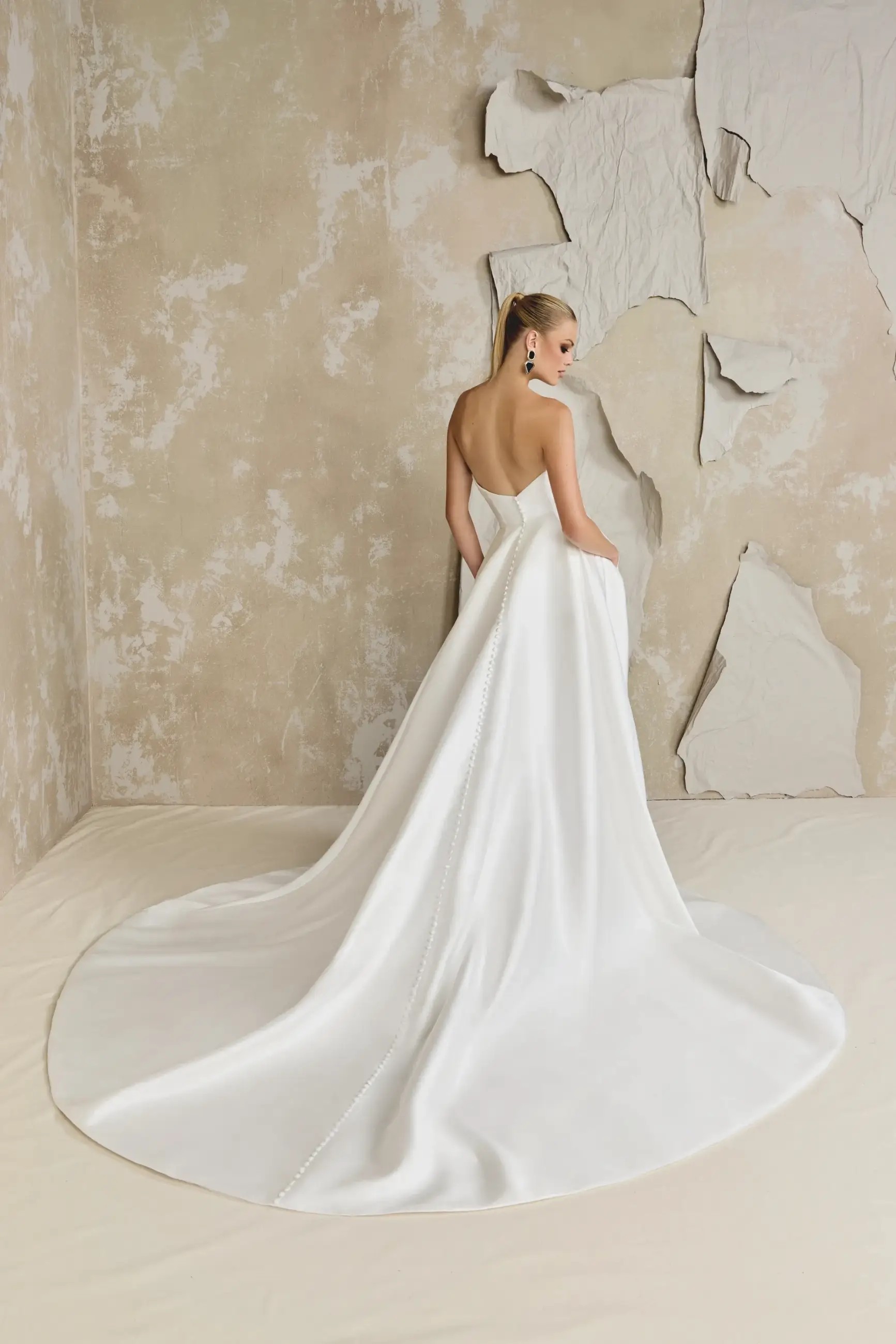 Model is wearing a silk mikado a-line wedding dress by justin alexander 