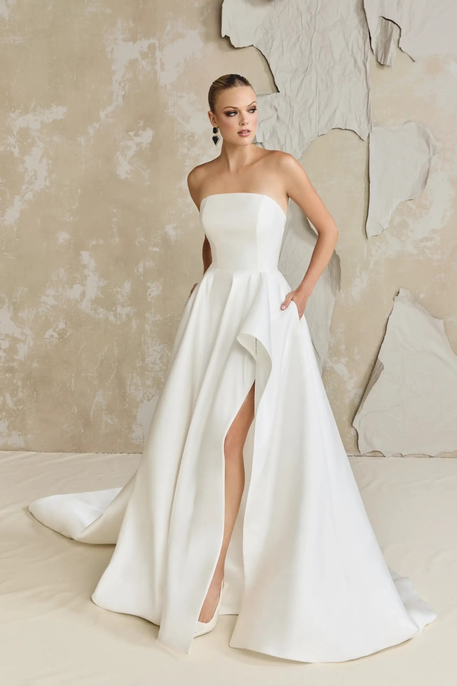 Model is wearing a silk mikado a-line wedding dress by justin alexander 