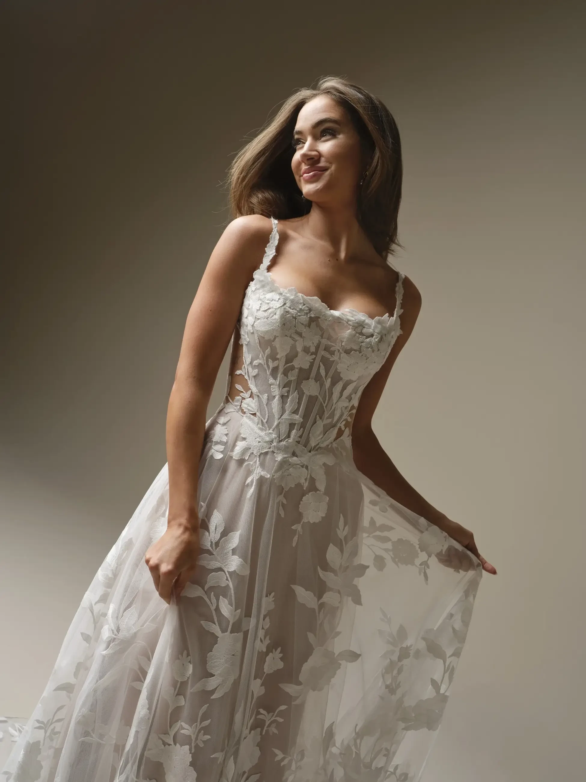 model is wearing a sleeveless a-line bridal gown