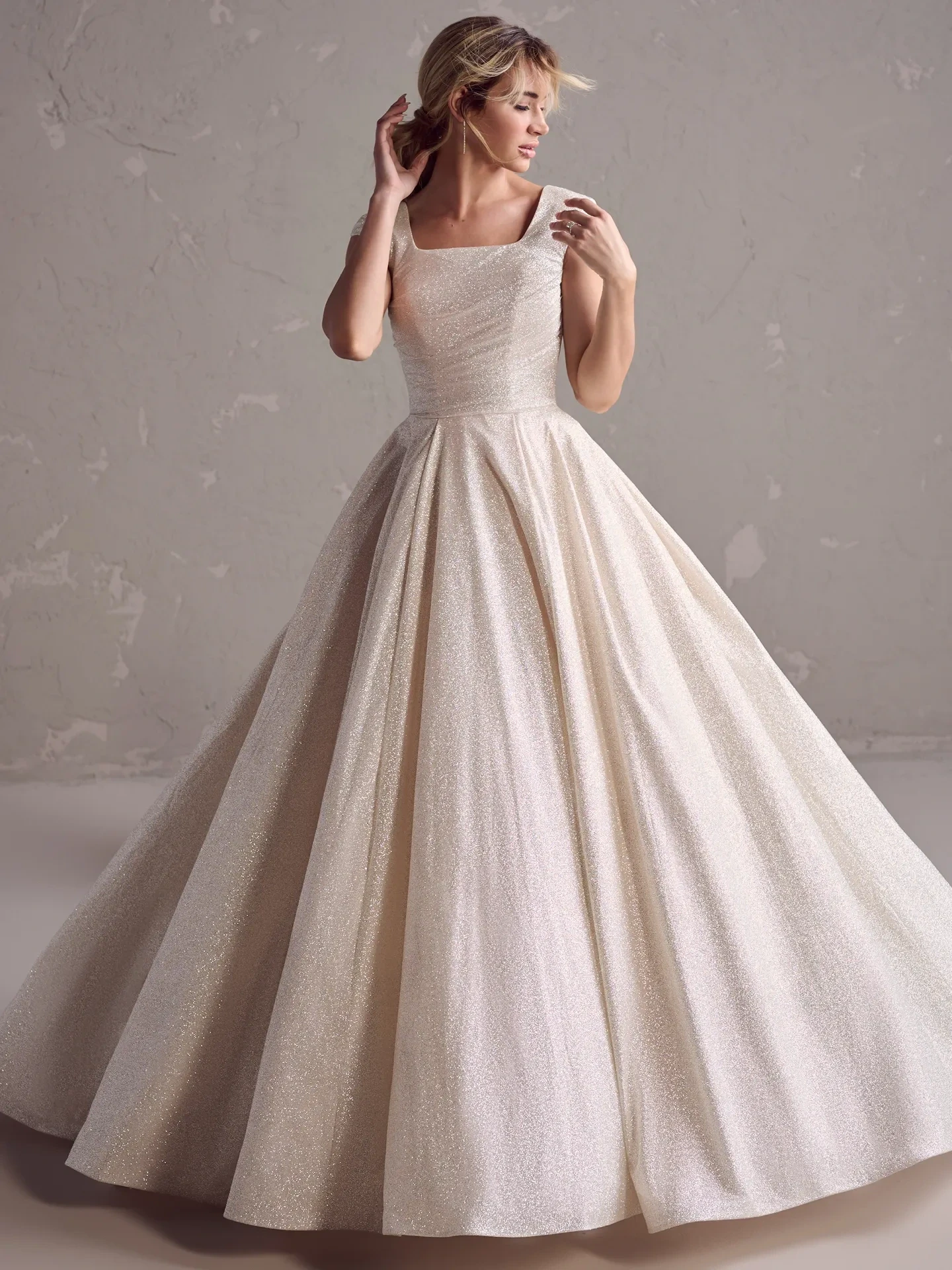 model is wearing a strapless basque waist ball gown wedding dress