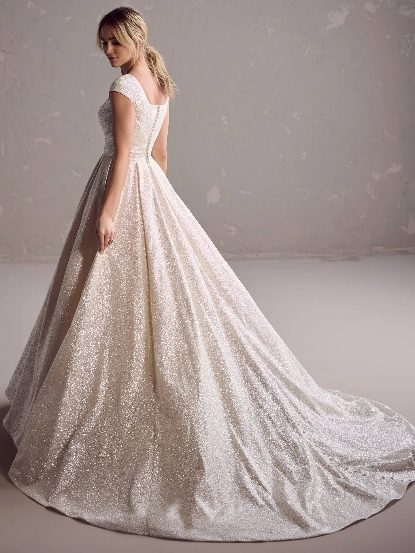 model is wearing a strapless basque waist ball gown wedding dress
