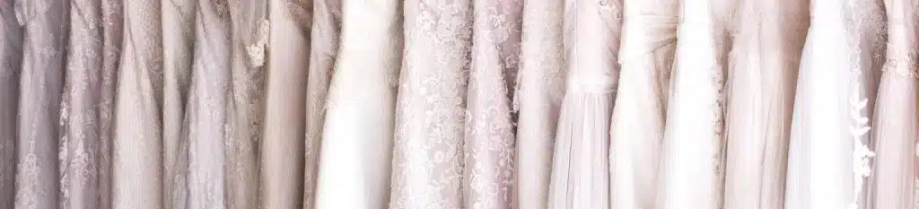 dresses hung up on a wrap showing all different types of materials