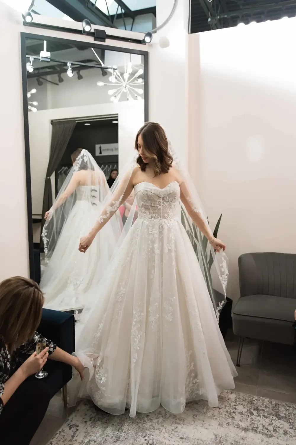 image shows a bride trying on a wedding gown