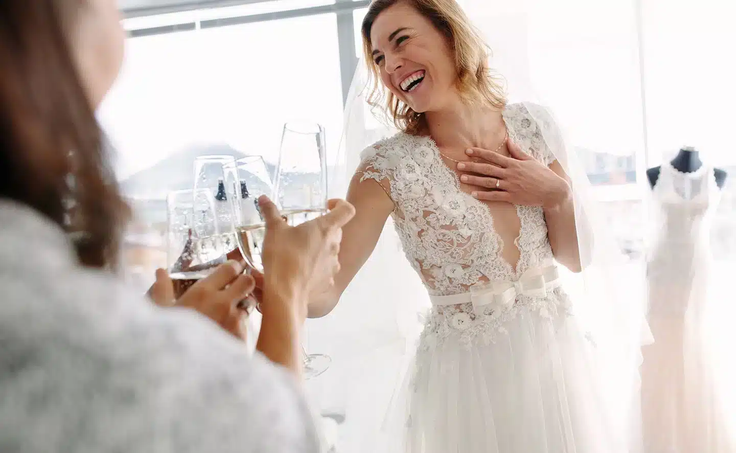 Bride cheers with family after saying yes to her dress