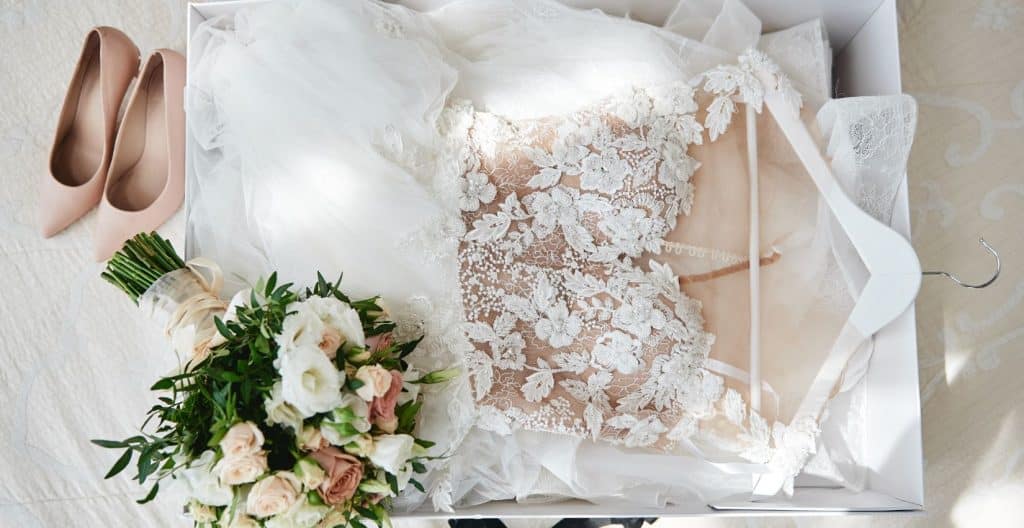 Wedding dress, bouquet, and shoes, overhead view