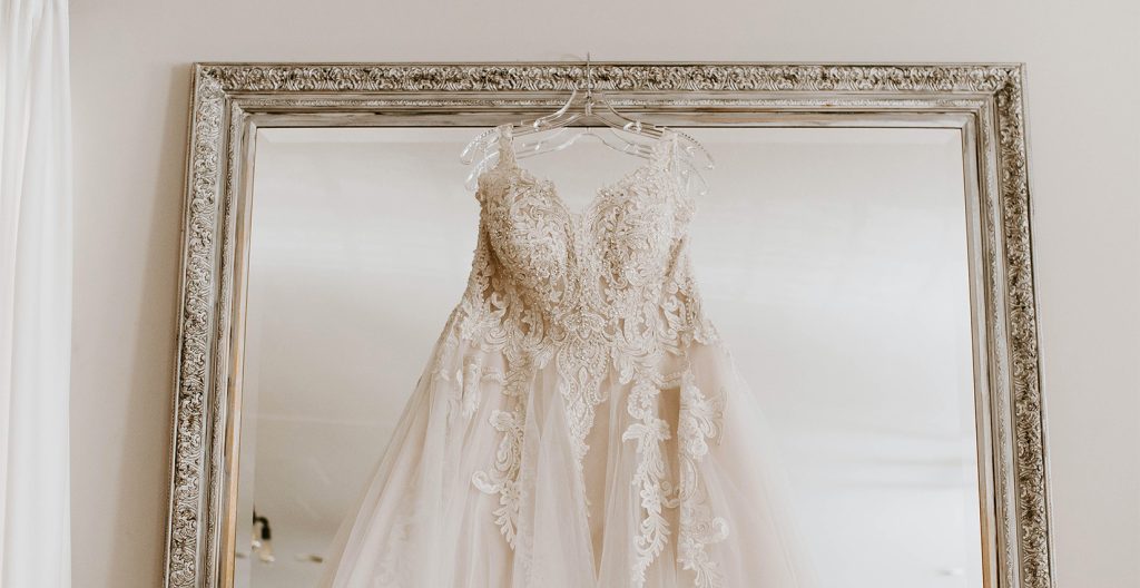 Hanging Wedding dress in-front of mirror