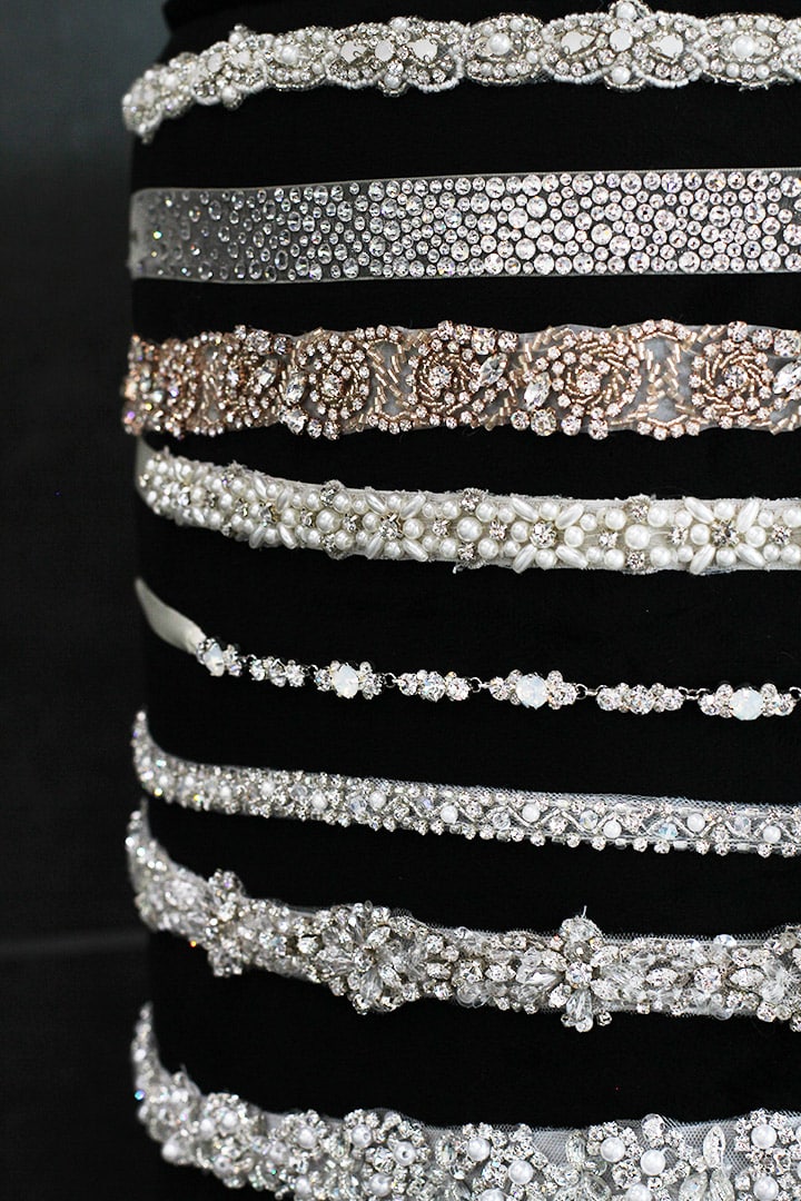 Stack of wedding gown belts with diamonds and pearls