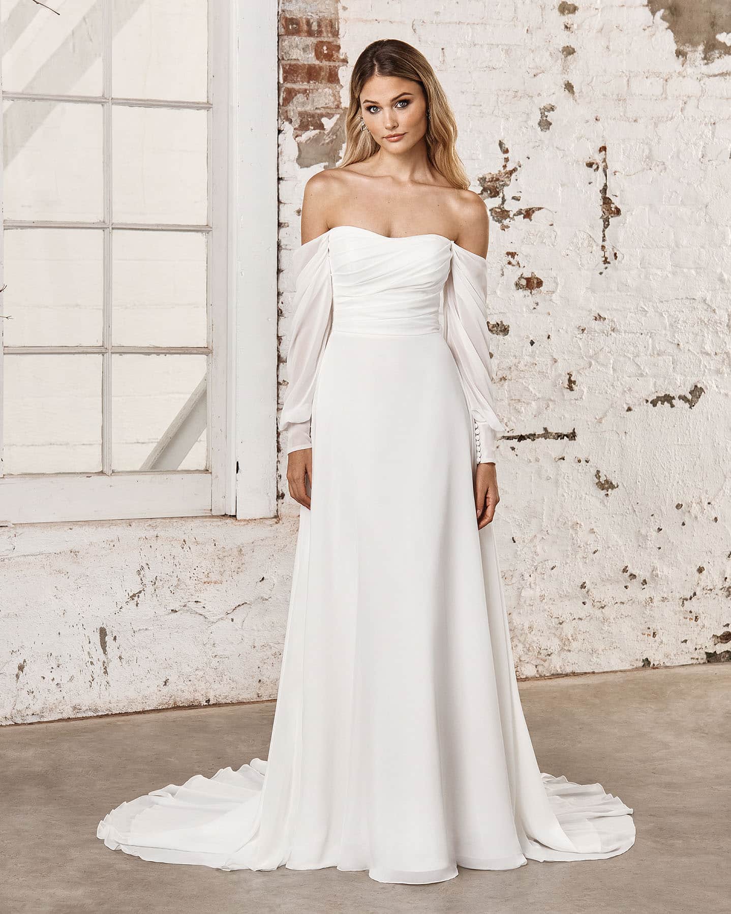 Bride with blonde hair wearing strapless, long-sleeve wedding dress