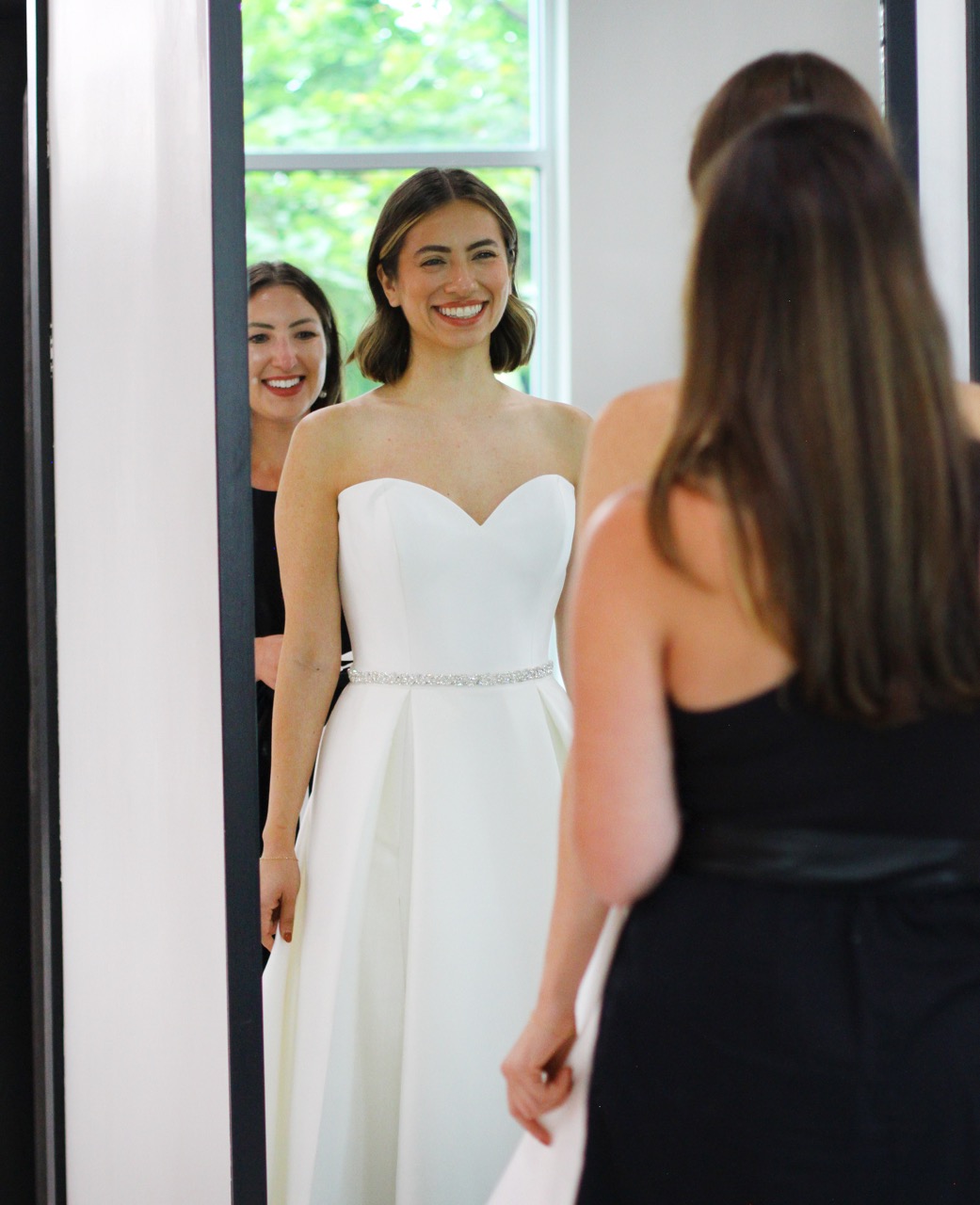 Bride looking in the mirror after finding her drea, wedding dress