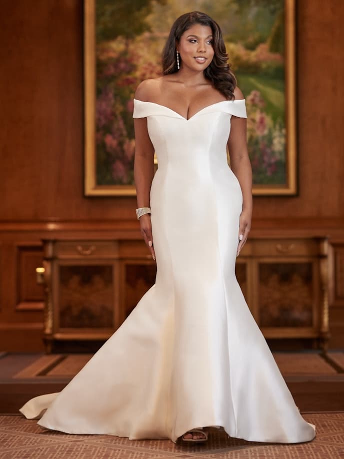 African American woman wearing Maggie Sottero off-the-shoulder wedding dress